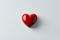 Glossy red heart shape on white background with soft shadow, minimalist romantic symbol isolated for valentines designs and love concepts.