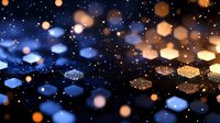Glowing golden and blue bokeh lights creating magical atmosphere against dark background, abstract defocused pattern with hexagonal shapes and sparkles.
