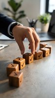 Businessman hand arranging wooden blocks with checkmarks in office environment representing step-by-step progress and achievement in corporate planning.