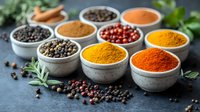 Vibrant aromatic spices and peppercorns in concrete bowls on dark background, including turmeric, paprika, and black pepper. Fresh herbs and scattered spices.