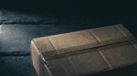 Vintage brown cardboard package tied with string on dark slate surface. Retro shipping box for delivery, postal service, and e-commerce concepts.