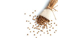 Scattered chickpeas spilling from rustic linen bag tied with twine on white background, isolated food composition for healthy eating and cooking concepts.