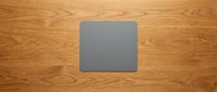 Gray square blank template on natural wood grain surface for mockup design and branding projects.