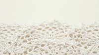 White delicate lace fabric texture with intricate floral patterns and openwork design on neutral background for wedding and fashion projects.