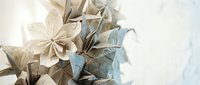 Delicate origami paper flowers in soft neutral tones arranged as decorative bouquet on white background for crafting and artistic projects.