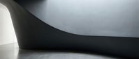 Modern minimalist interior with curved concrete walls and dramatic lighting creating abstract architectural shadows and geometric forms.