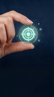 Hand holding glowing target symbol with digital effects representing business goals, strategy planning and precision targeting for marketing campaigns.