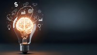 Glowing light bulb with brain inside surrounded by business icons representing innovation, creativity and entrepreneurship on dark background.