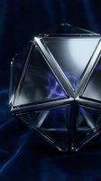 Geometric crystal prism with triangular facets reflecting blue and white light against dark background, suitable for luxury cosmetics, skincare packaging, and premium product design.