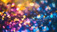 Abstract colorful bokeh lights background with golden, pink, purple and blue glowing circles creating magical sparkle effect for festive designs.