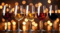 Wine glasses filled with different varieties against golden bokeh lights background, elegant composition showcasing red, white and rose wines for restaurant menu or tasting event.