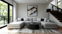 Modern minimalist living room with grey sectional sofa, black round coffee table, abstract wall art, and floor-to-ceiling windows overlooking natural scenery.