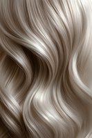 Flowing platinum blonde wavy hair texture with soft highlights and natural movement creates luxurious background for beauty and fashion designs.