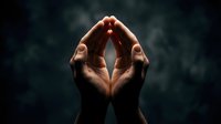 Two hands raised together forming a sacred arch shape against a dark moody background, symbolizing prayer, faith, and spiritual connection.
