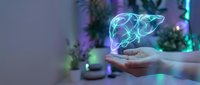 Glowing holographic liver organ floating above open palm in modern medical technology concept for healthcare innovation and digital medicine applications.