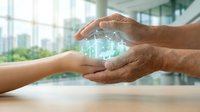 Adult male and young child with light skin tone exchanging glowing digital globe hologram, symbolizing knowledge transfer, mentorship, and sustainable business practices in modern office environment.