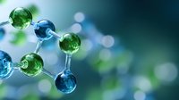 Molecular structure with green and blue glass spheres connected by silver rods on blurred bokeh background, scientific concept for chemistry and biology research.