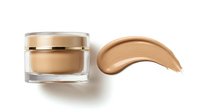 Luxury foundation jar with golden cap and creamy beige makeup smear isolated on white background for cosmetic advertising and beauty product design.
