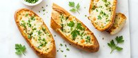 Golden baked potato skins topped with melted cheese and fresh herbs on white background. Comfort food appetizer for restaurant menus and cooking blogs.