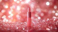 Pink lipstick on glittering coral background with bokeh lights and sparkles creating luxurious cosmetic product photography composition for beauty advertising.