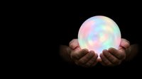 Hands holding glowing orb with pastel rainbow light against dark background, representing energy, magic, hope, and future possibilities for spiritual and wellness concepts.