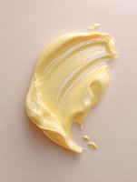 Creamy yellow cosmetic texture smear on beige background, showing smooth glossy skincare product consistency for beauty and makeup advertising.