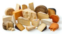 Assorted cheese varieties including cheddar, parmesan, and aged blocks isolated on white background for food photography, culinary design, and gourmet product marketing.