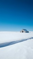 Isolated farmhouse with blue roof standing alone in vast snowy winter landscape with frozen stream, clear sky, minimalist rural scenery for design projects.
