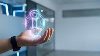 Businessman hand holding glowing digital hologram with circular tech interface in modern office environment for futuristic business technology concepts.