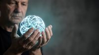 Senior businessman holding glowing digital network sphere representing global connectivity and technology innovation in corporate environment.