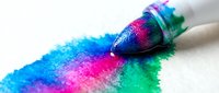 Paintbrush with vibrant neon blue, pink, and green paint strokes on white background, isolated for design and creative projects.