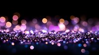 Magical purple and pink bokeh lights scattered on dark background creating dreamy atmosphere. Glowing defocused sparkles for festive designs.
