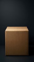 Closed cardboard shipping box with kraft paper construction isolated on dark background, suitable for packaging, logistics, delivery, and e-commerce design projects.
