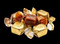 Assorted wrapped candies in gold and amber foil isolated on transparent background, ready for clipart, t-shirt design, print-on-demand products, stickers, and sublimation projects.