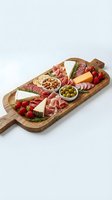 Gourmet charcuterie board with assorted meats, cheeses, nuts and berries on rustic wooden serving platter for entertaining and appetizer presentations.