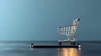Shopping cart on smartphone screen glowing with blue light, concept of mobile commerce and digital retail shopping experience on dark background.