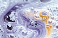 Abstract purple and gold liquid marble texture with bubbles and swirls creating organic flowing patterns for modern design backgrounds and artistic projects.