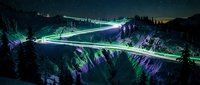 Long exposure light trails flowing through mountain canyon at night with neon green and purple glow, ideal for sci-fi, technology, and futuristic design projects.