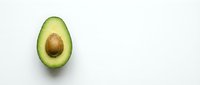 Fresh avocado half with pit on clean white background. Healthy organic fruit isolated for cooking, nutrition and diet concepts. Natural food ingredient.