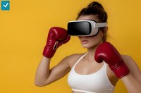 Young athletic woman in white sports bra wearing VR headset and red boxing gloves against yellow background, ready for virtual fitness training session.