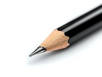Sharp graphite pencil tip close-up on white background, showing wood texture and metallic lead point. Minimalist composition for creative and educational concepts.