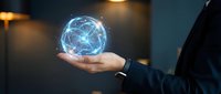 Businessman in dark suit holding glowing digital globe with blue network connections, representing global technology, innovation, and worldwide business connectivity.