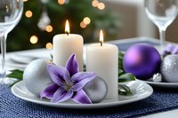 Festive table setting with burning white candles, purple lily flower, silver and purple ornaments against blurred Christmas lights background.