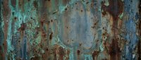 Weathered metal surface with peeling turquoise paint and rust corrosion creating abstract textural patterns for industrial design backgrounds.