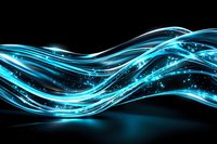 Glowing blue waves of light with sparkles flow across dark background creating dynamic motion effect for technology and energy designs.