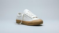 White low-top canvas sneaker with gum rubber sole on light gray background, casual unisex footwear for fashion, sport, and lifestyle design projects.