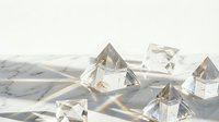 Clear crystal pyramids on marble surface creating rainbow light reflections and prisms for meditation, healing, spiritual practices and luxury decor.