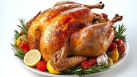 Roasted golden brown turkey garnished with fresh rosemary sprigs, citrus slices, cranberries and garlic cloves on white plate, traditional holiday meal.