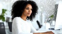Young African American businesswoman with natural curly hair wearing white sweater working at modern office desk with computer and digital network overlay.