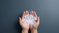 Human hands cupped together holding glowing transparent lungs symbol representing respiratory health, medical care and breathing wellness concept.